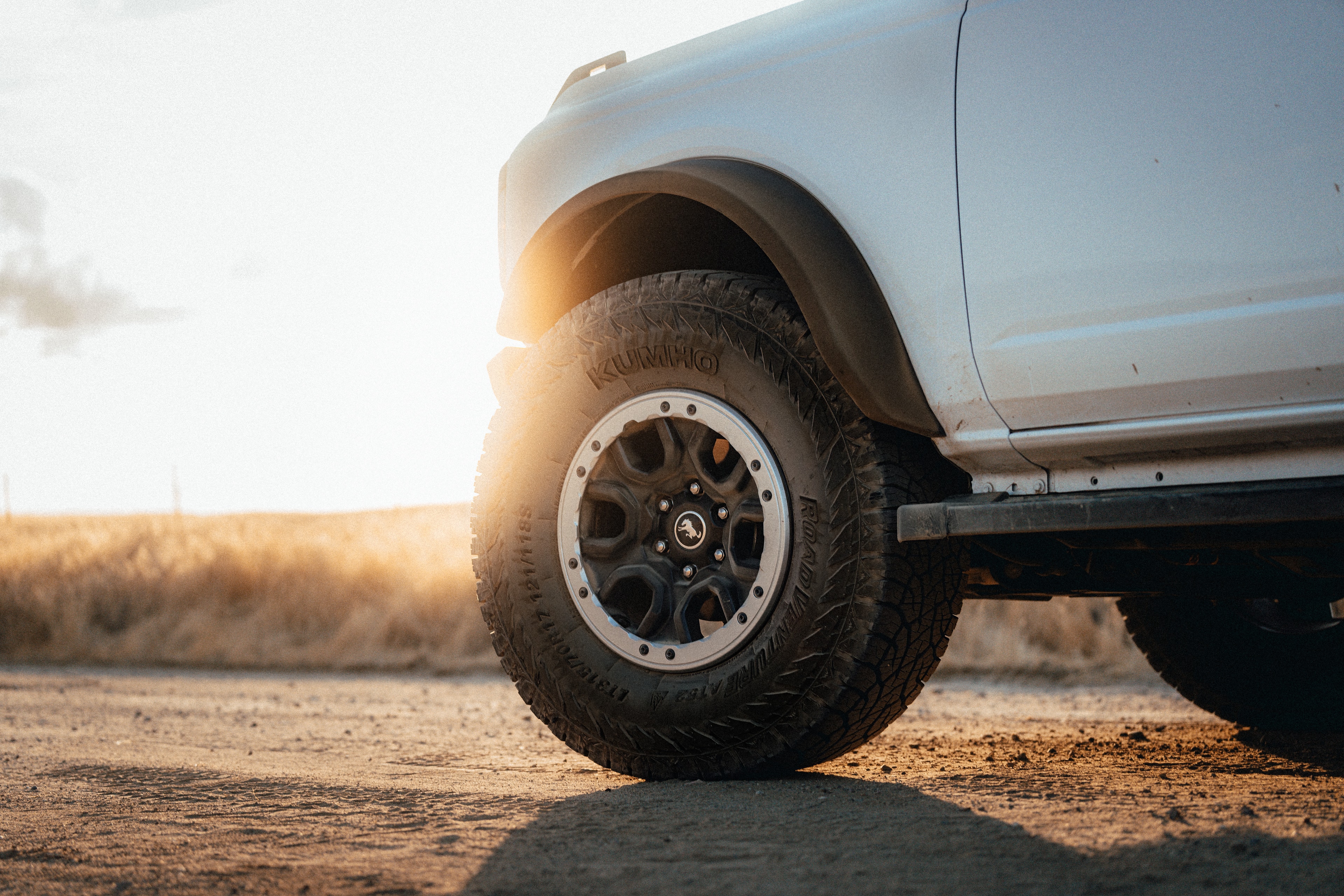 Ford Bronco wheel detail with the KUMHO sidewall logo at sunset