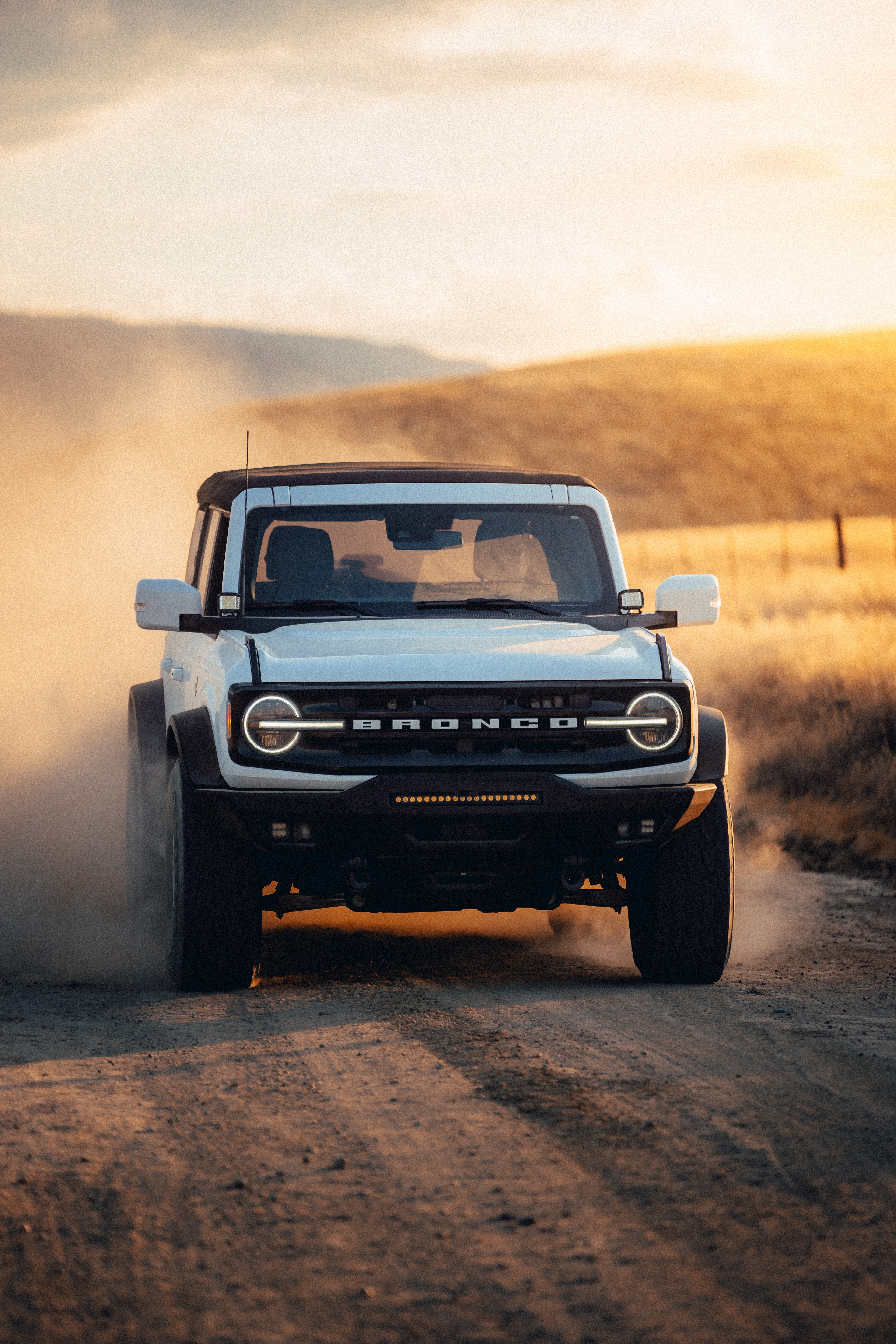 Ford Bronco — portrait, dust at sunset
