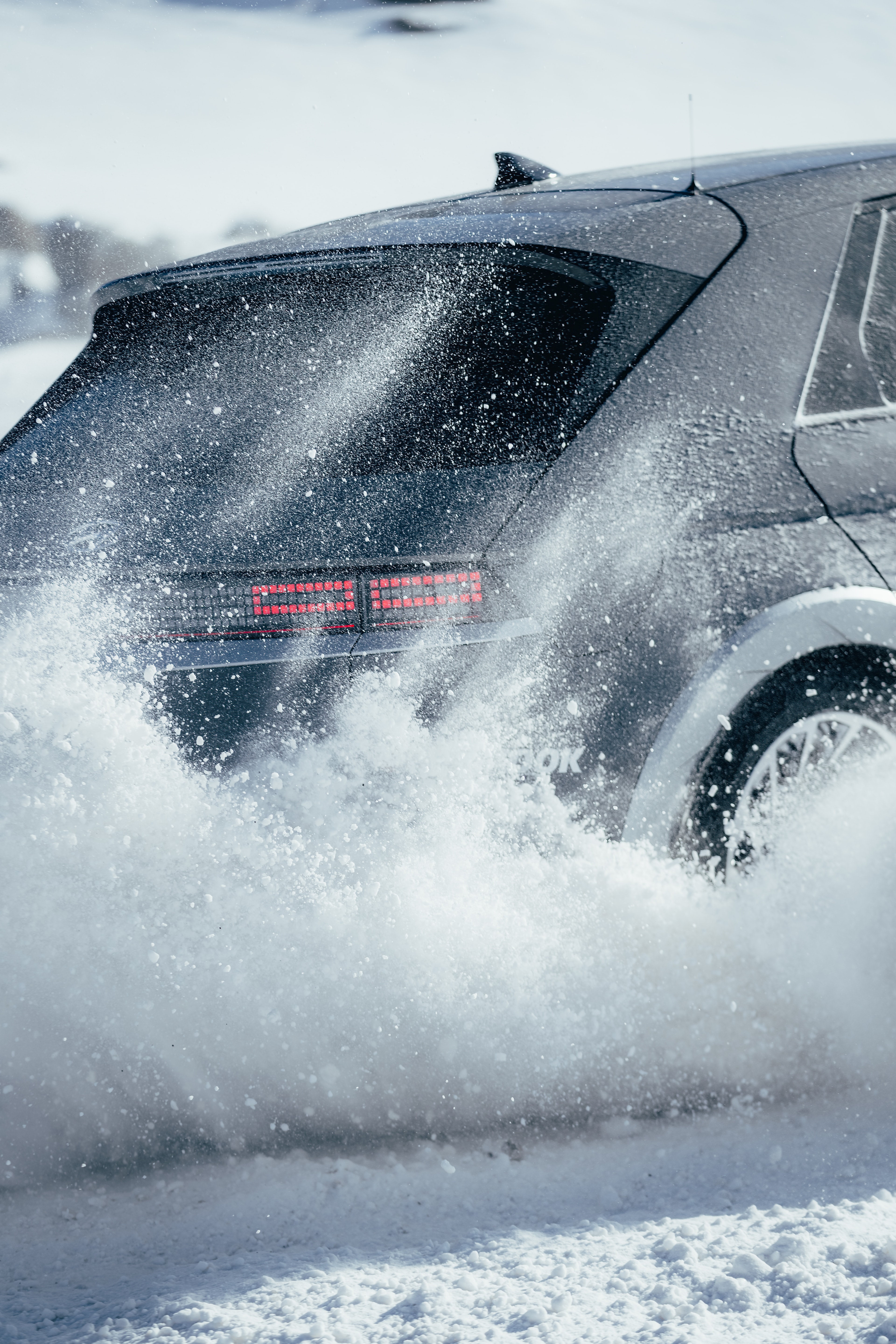 Hyundai IONIQ 5 drifting on the glacier, spraying a wall of snow powder