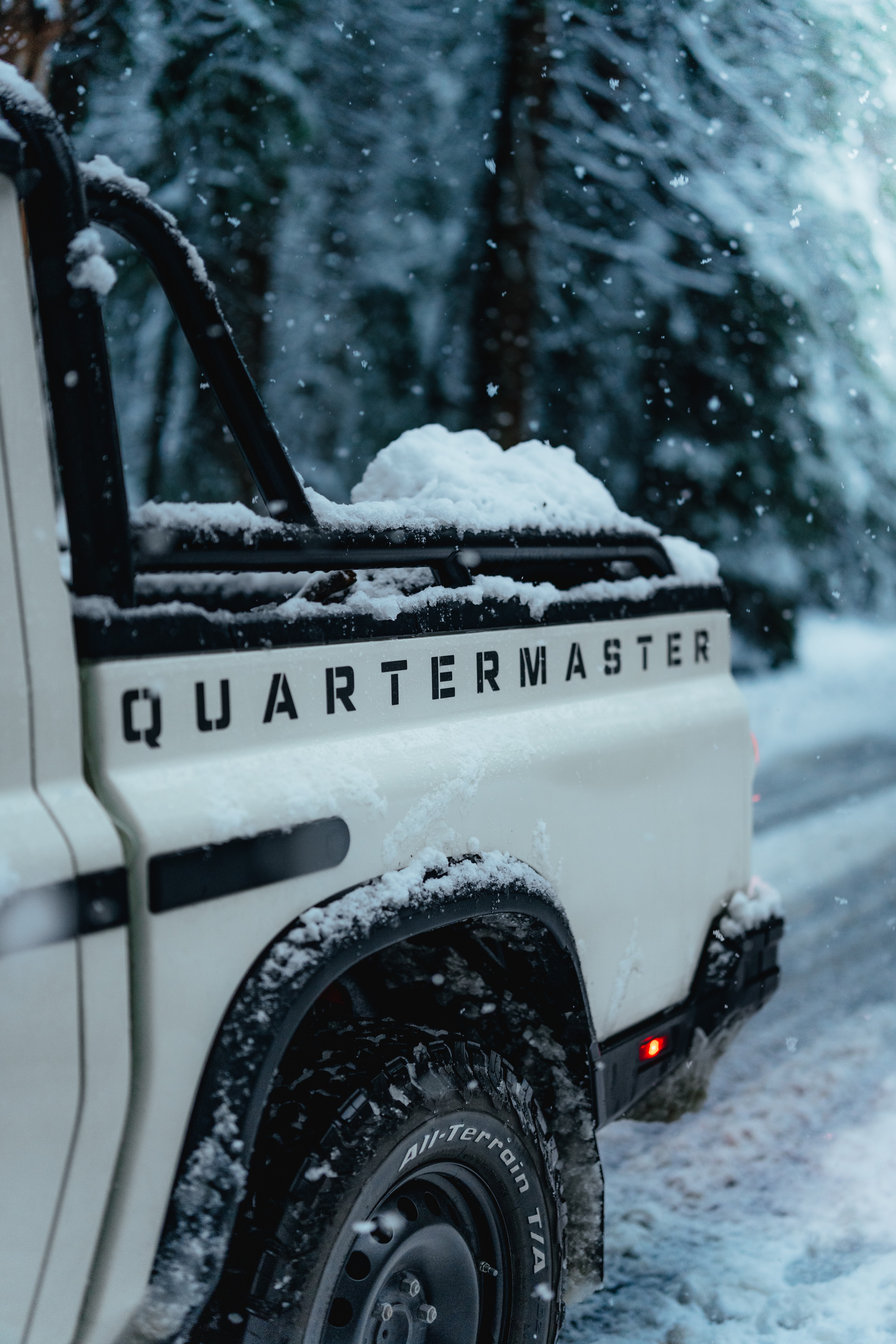 QUARTERMASTER lettering on the snow-filled truck bed, BFGoodrich tire