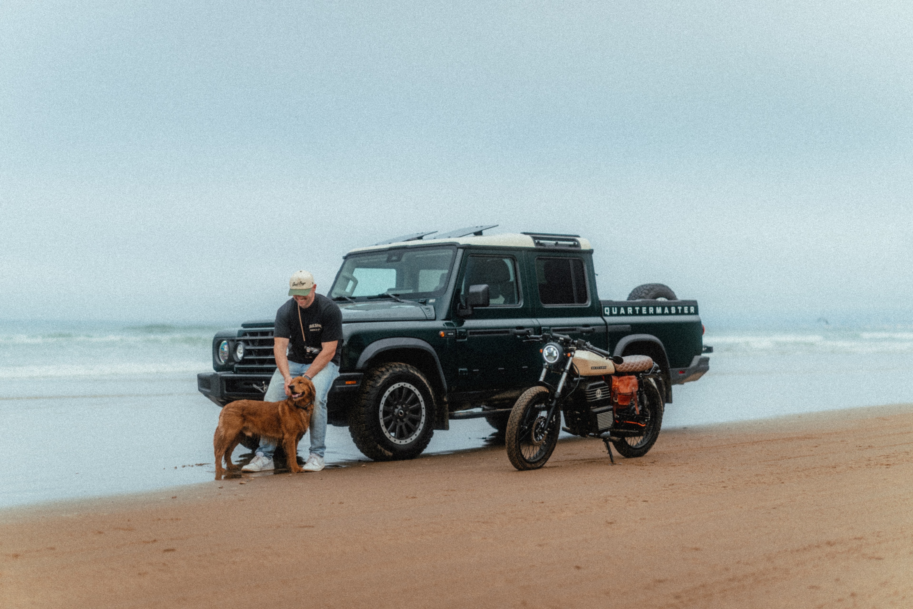 Rider and a golden retriever beside the Beachman and the Quartermaster on the Pismo sand