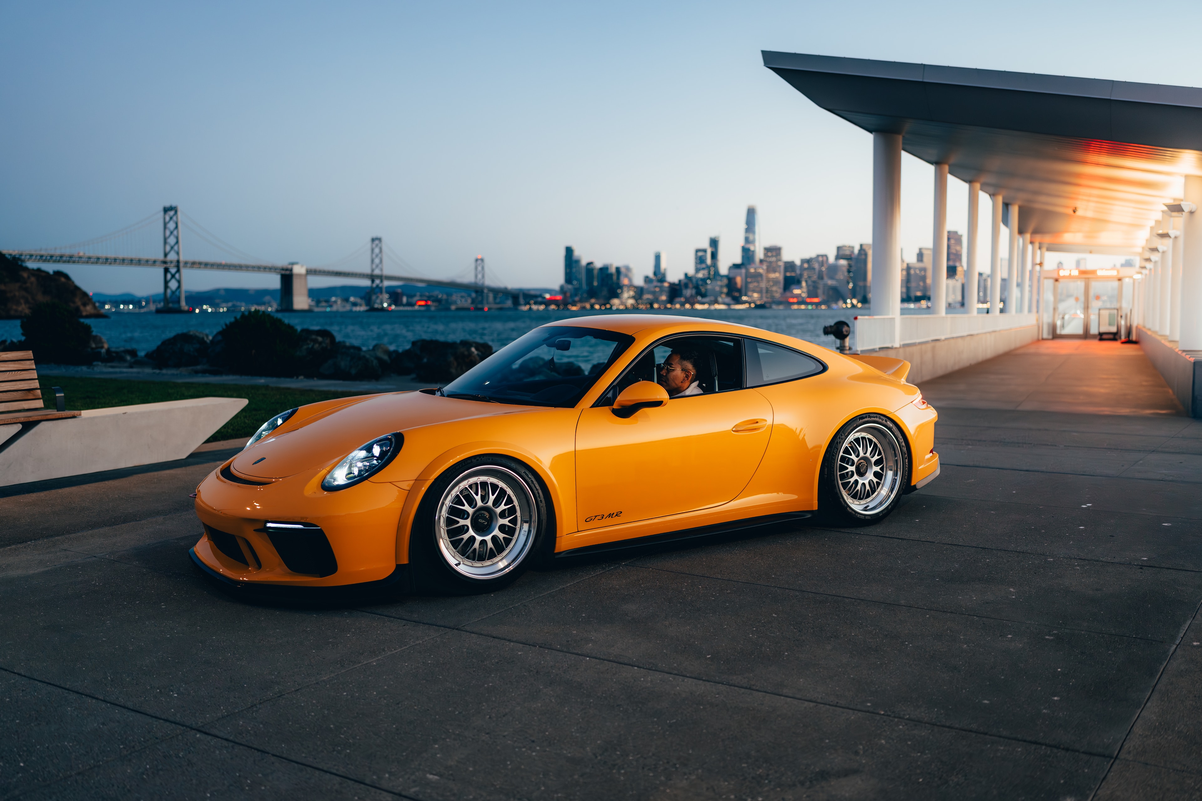 911 GT3 on Treasure Island at twilight, city skyline lights coming on