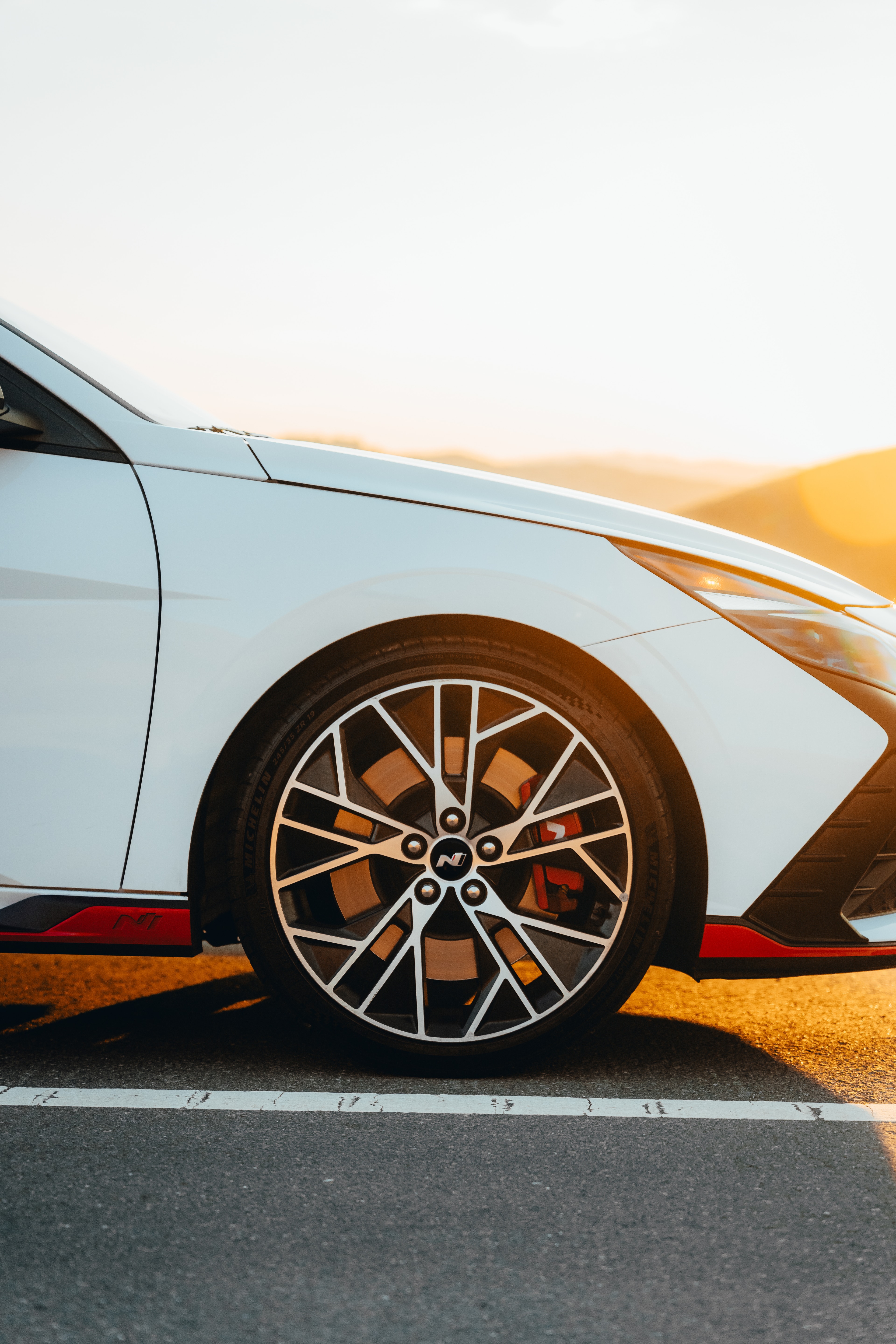 Hyundai Elantra N wheel detail with red brake caliper, sunset flare