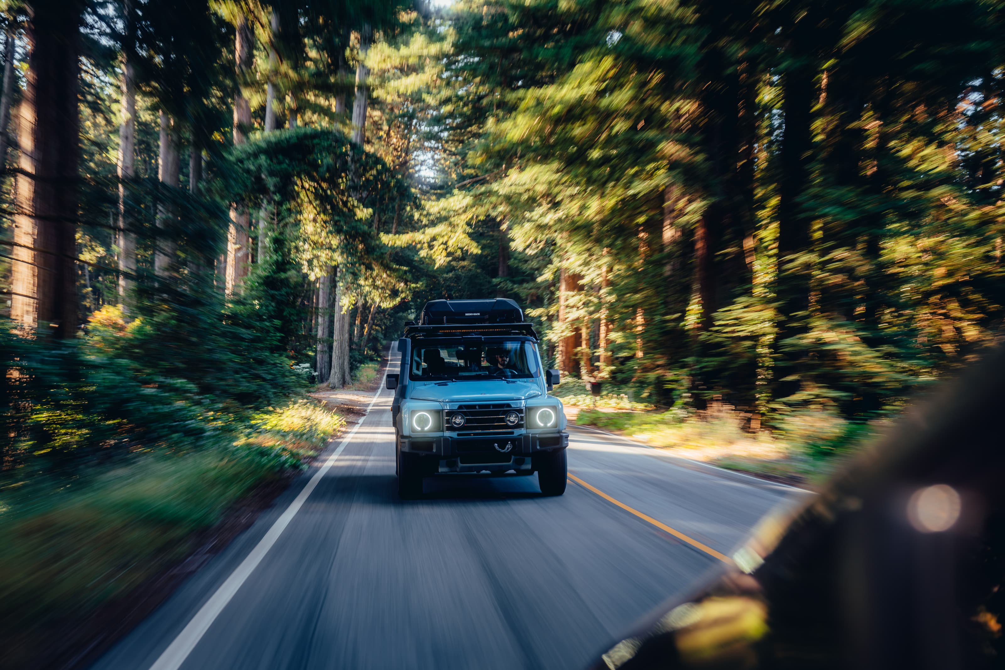 INEOS Grenadier in motion on a redwood road, motion blur