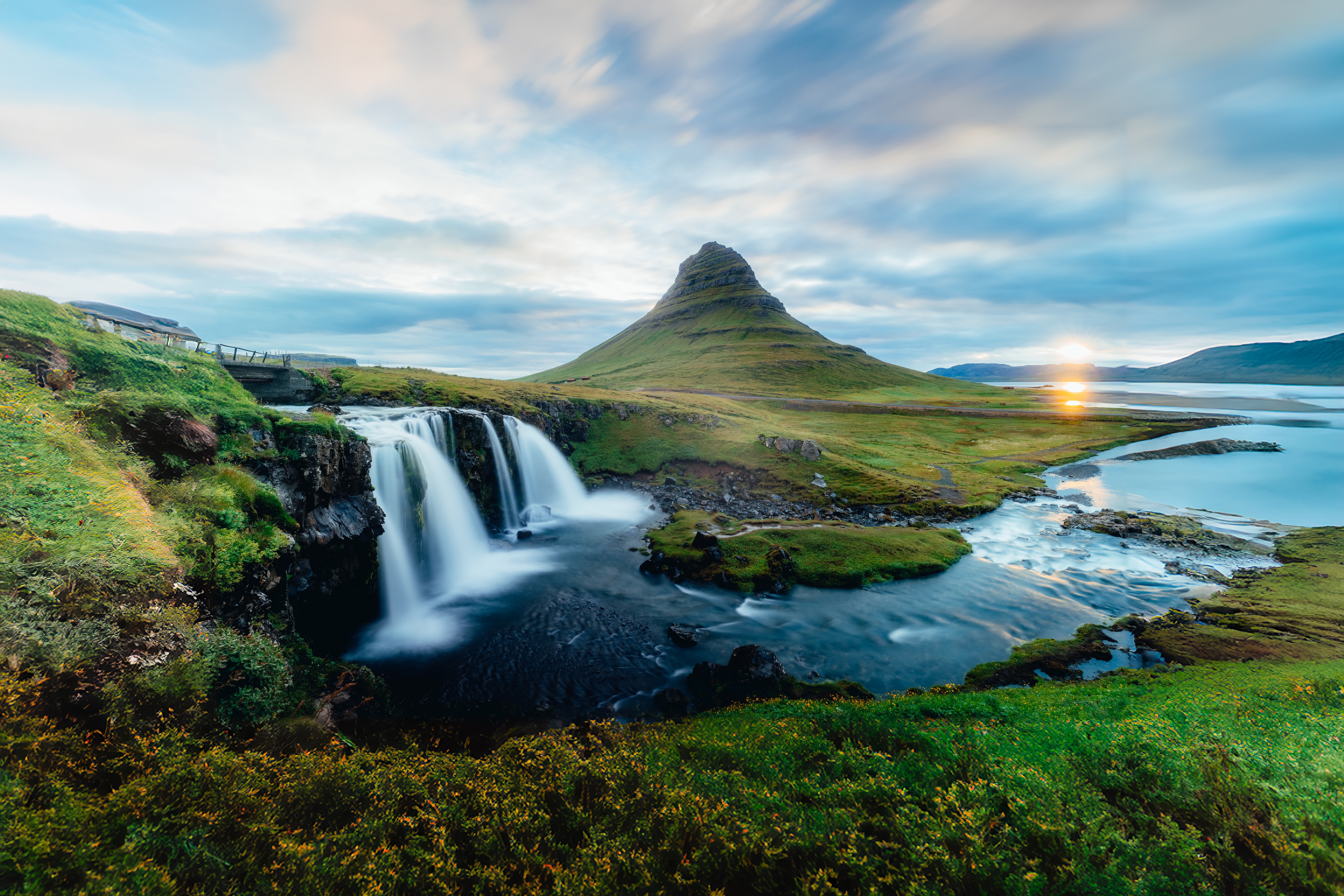 Kirkjufell mountain and Kirkjufellsfoss waterfall under a soft sunset