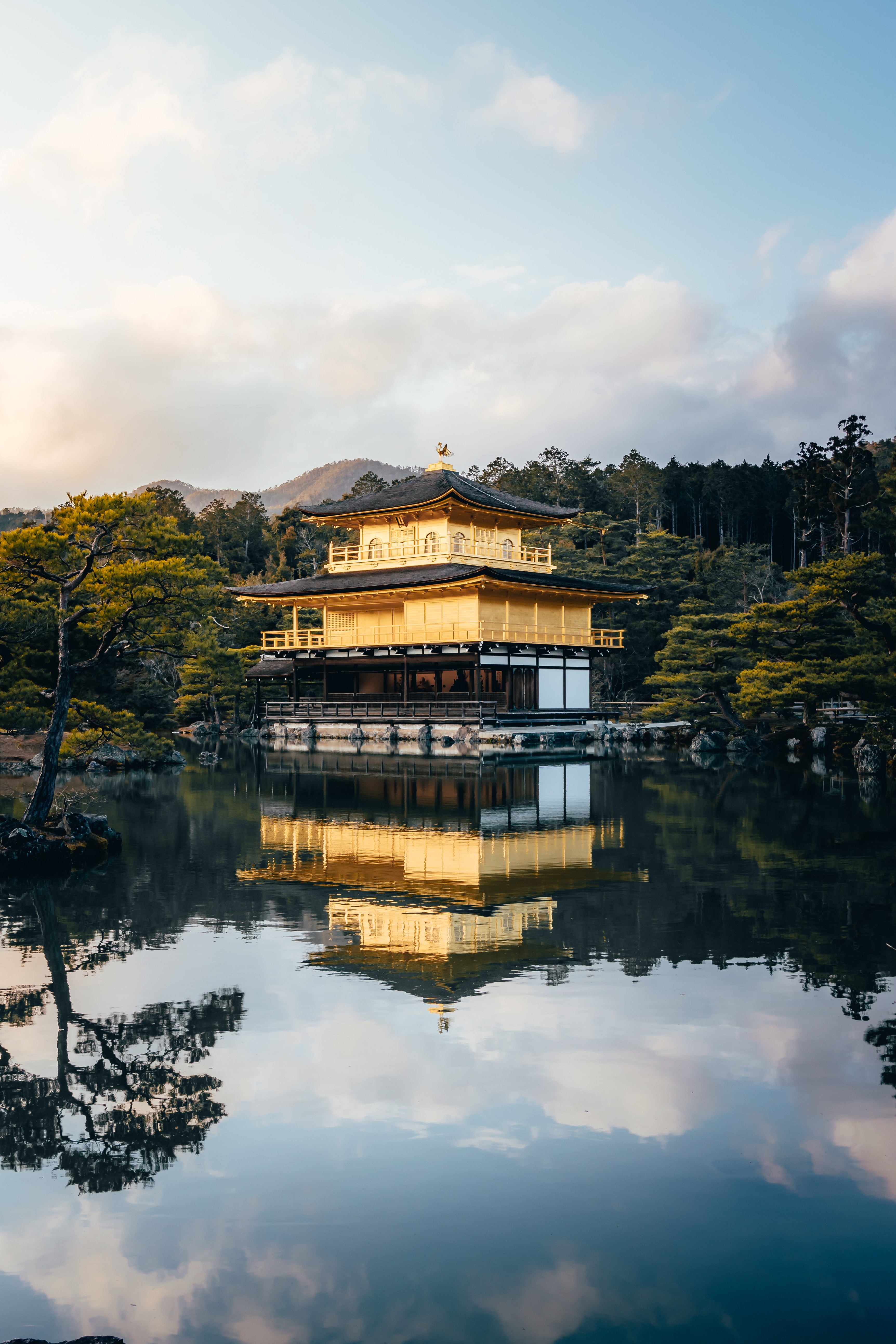 Kinkaku-ji, the Golden Pavilion, mirrored in its still pond at golden hour