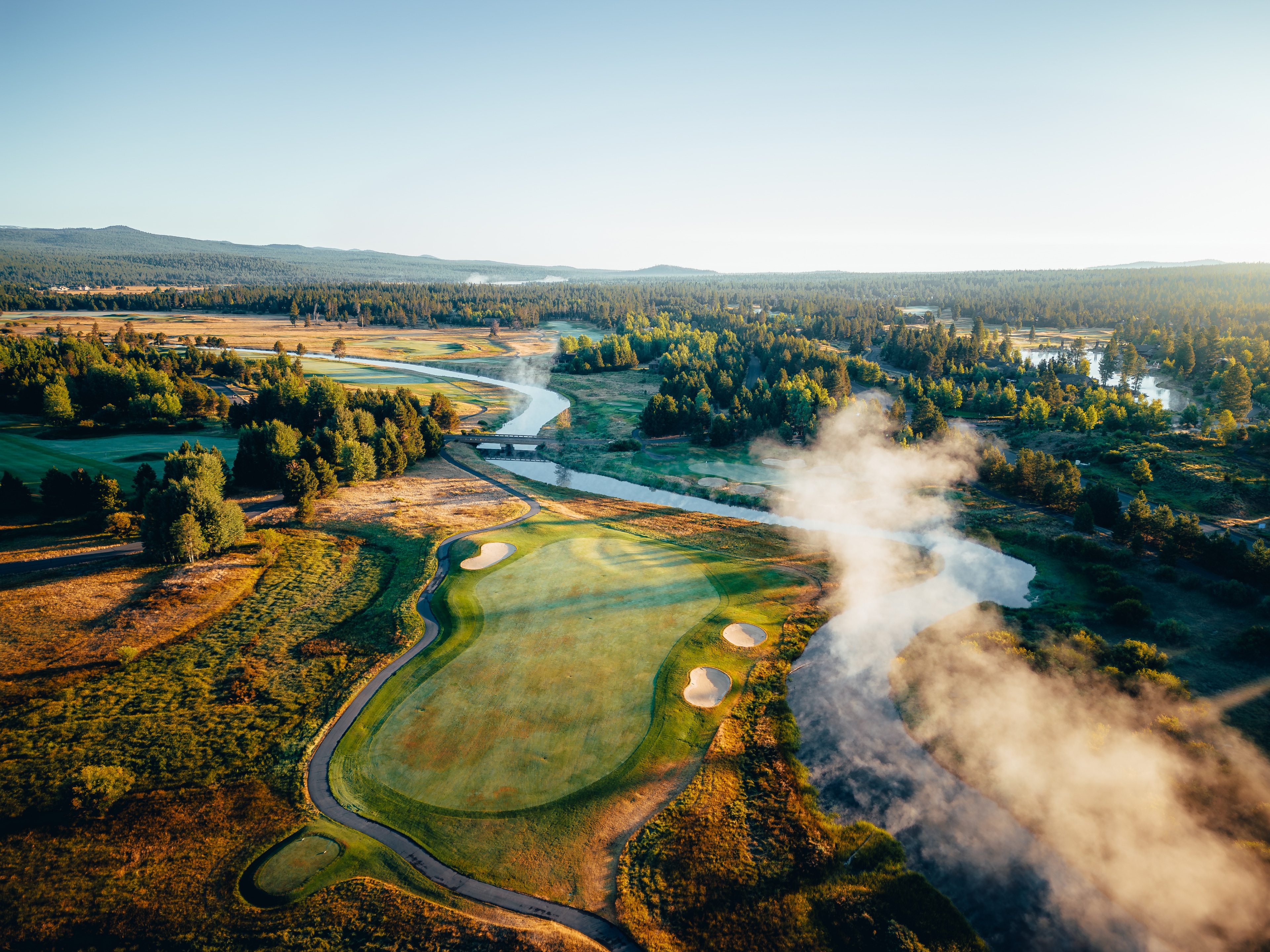 Morning steam rising off the river as it winds through the Crosswater course, aerial view
